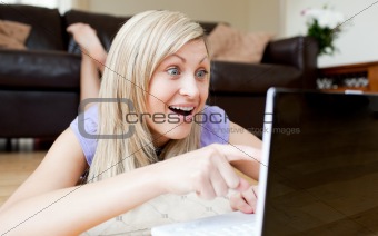 Astonished woman using a laptop
