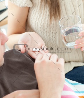 Cute woman give medicine to her husband her husband 