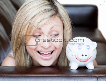 Happy woman using a piggybank 