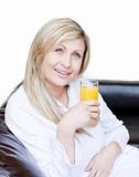 Radiant woman drinking an orange jus 