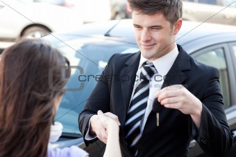 Attractive businessman talking on the phone in a car