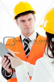 Charismatic architect discussing with his colleague against a white background