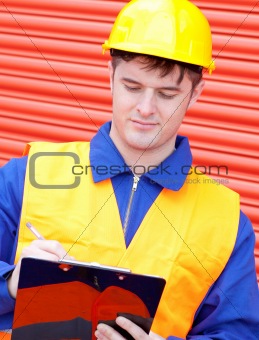 Mature male engineer writing his report 