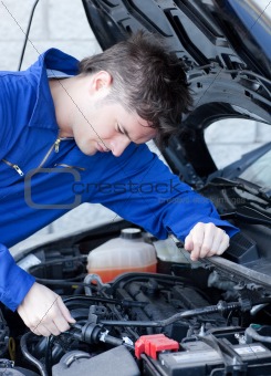 Self-assured man repairing a car 