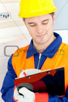 Confident electrician repairing a power plan