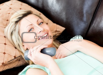 Happy woman using a remote 