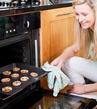 Beautiful housewife preparing cookies