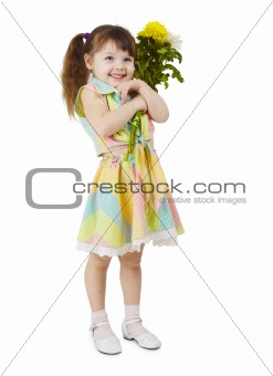 Happy little girl holds bouquet of flowers
