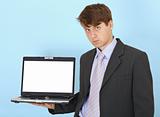 Serious businessman holds on hand laptop