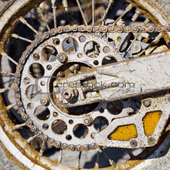 Rear wheel of motorcycle with chain covered with dirt