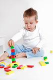 Lovely boy playing with blocks