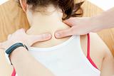 Close-up of a brunette woman receiving a back massage