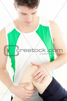 Attractive physical therapist checking a woman's knee 