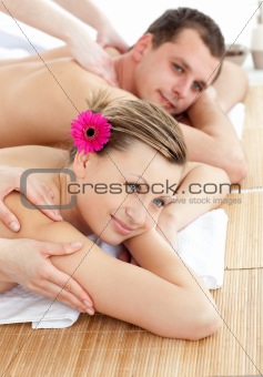 Smiling young couple receiving a back massage