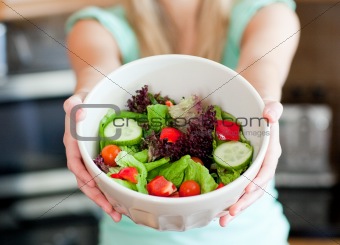Young woman showing a salad 
