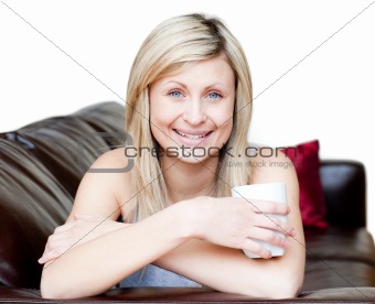 Cheerful woman holding a cup of coffee 