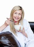 Delighted woman having a breakfast 