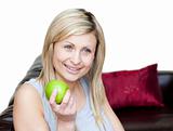 Happy woman eating an apple