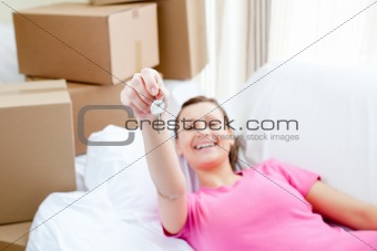Portrait of a beautiful woman relaxing on a sofa with boxes