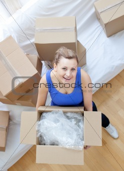 Smiling woman holding a box 