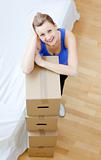 Smiling woman is moving various boxes 