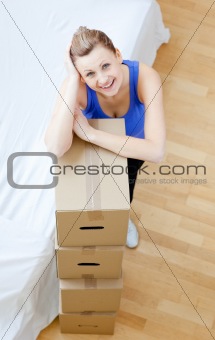 Smiling woman is moving various boxes 