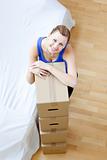 Attractive woman is moving various boxes 