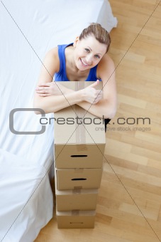 Attractive woman closing a box at home