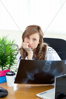 Happy female doctor holding a radiography