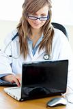Young attractive Female doctor working on a laptop