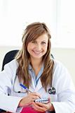 Smiling female doctor writing her diagnosis