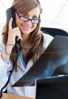 Happy female doctor talking on the phone