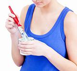 Confident woman using a paintbrush against a white background
