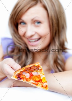 Delighted woman holding a pizza