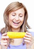 Smiling woman holding a corn 