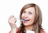 Cute woman eating a yogurt 