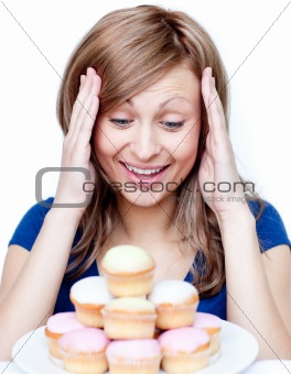 Astonished woman eating a cake