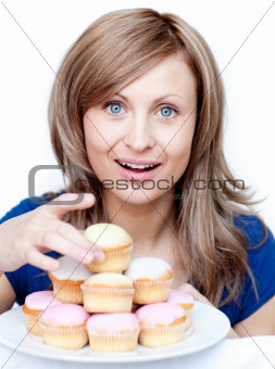 Bright woman holding a plate of cakes at home