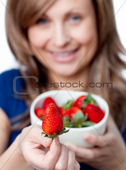 Cute woman eating strawberries 