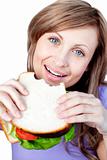Happy woman eating a sandwich