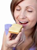 Young woman eating a cracker with cheese 
