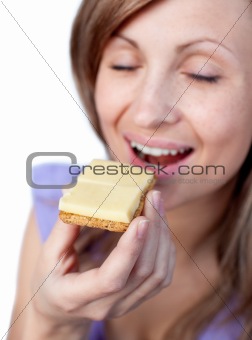 Young woman eating a cracker with cheese 
