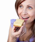 Radiant woman eating a cracker with cheese 