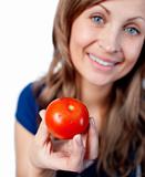 Smiling woman holding a tomato