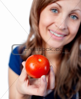 Smiling woman holding a tomato