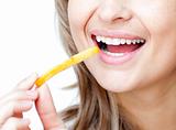 Close-up of a smiling woman eating fries 
