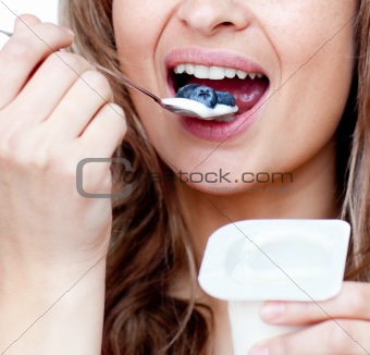 Close-up of a woman eating a yogurt 