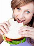 Delighted woman eating a burger