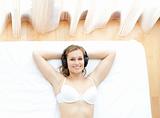 Relaxed woman in underwear listening music 