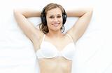 Attractive woman in underwear listening music 